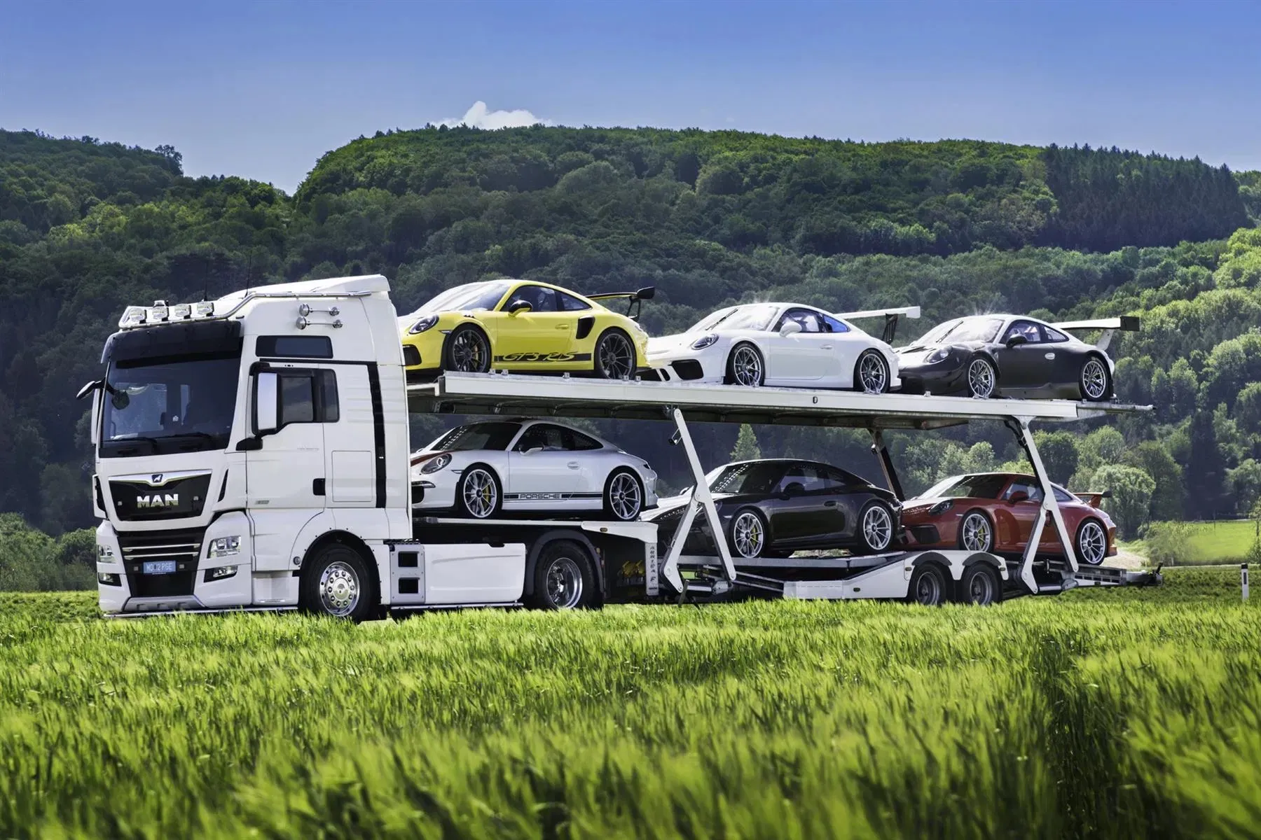 Six Porsche 911 GT3s for sale with transport truck